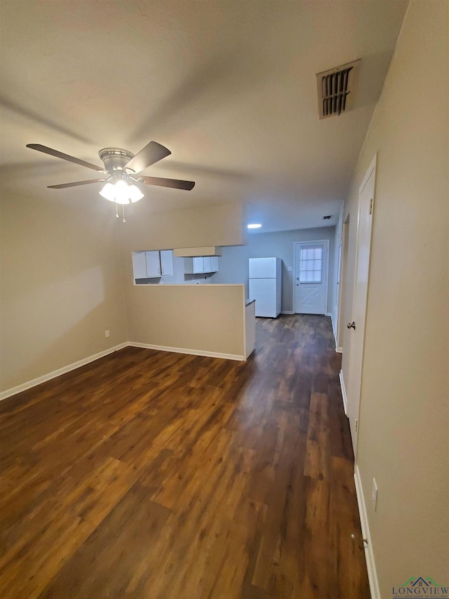Interior space featuring ceiling fan and dark hard