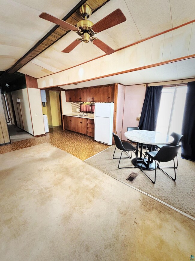 Dining room featuring a ceiling fan and visible ve