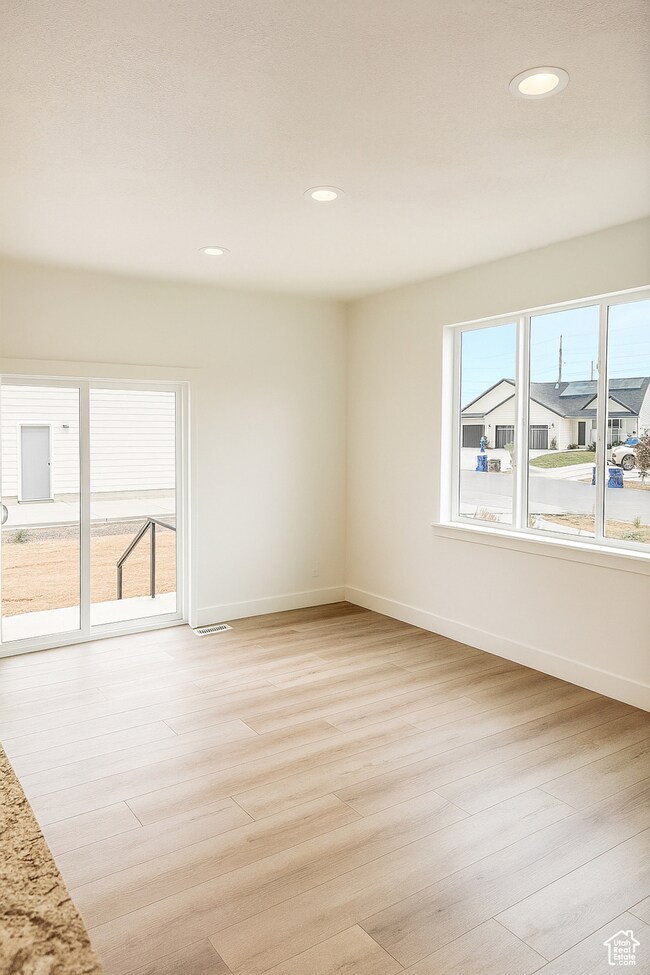 Unfurnished room with recessed lighting and light wood-style flooring