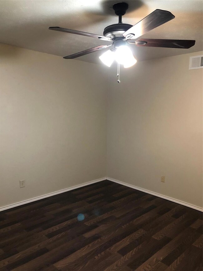 Unfurnished room with dark wood-type flooring and 