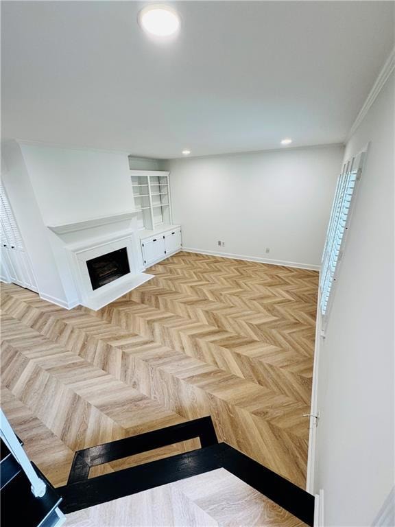 Unfurnished living room with a fireplace with flush hearth, recessed lighting, and baseboards