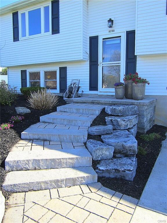 The gorgeous, custom-built stone walk & front porch makes for a very elegant entrance!  You'll notice the landing is slightly convex to allow water run-off and less ice build-up in the Winter.