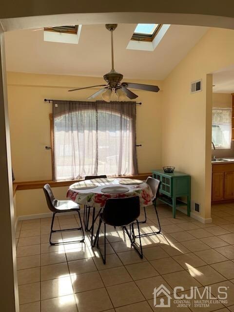 Eat in area off kitchen and formal dining room with cathedral ceiling and skylights as shown.