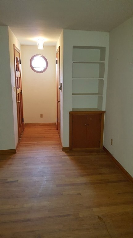 Entry way with coat closet and built in shelves an
