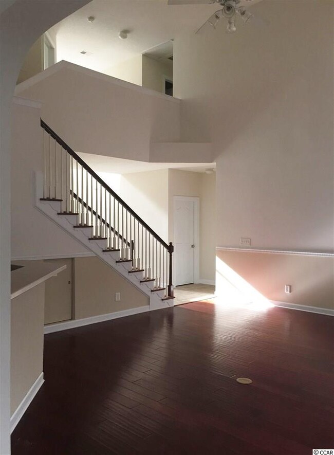 laminate flooring with fireplace, high ceilings an
