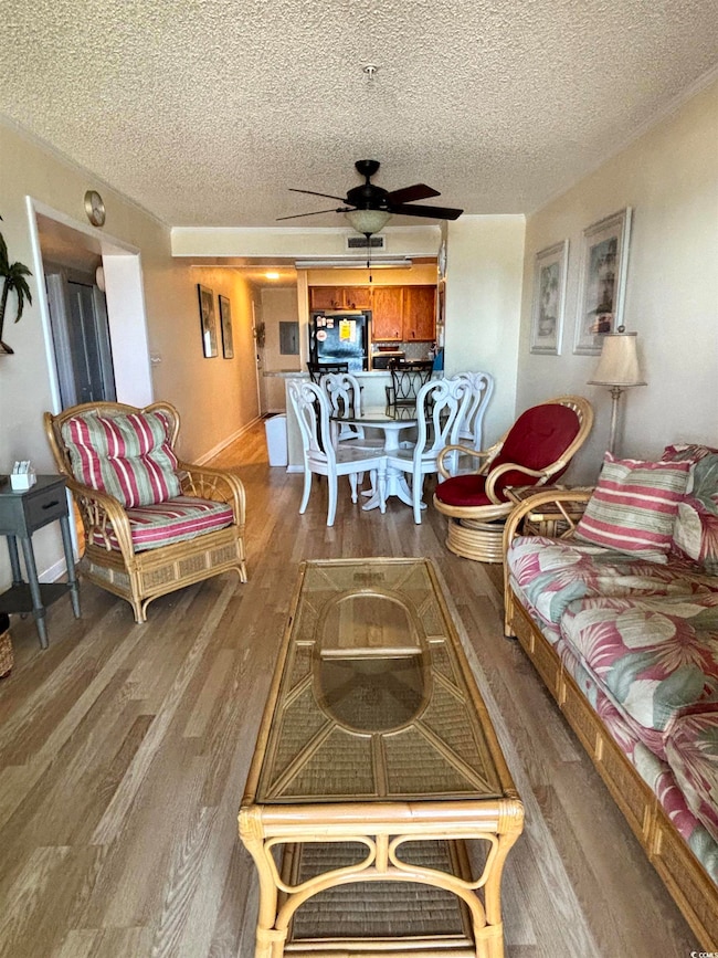 Living room featuring ceiling fan, wood-type floor