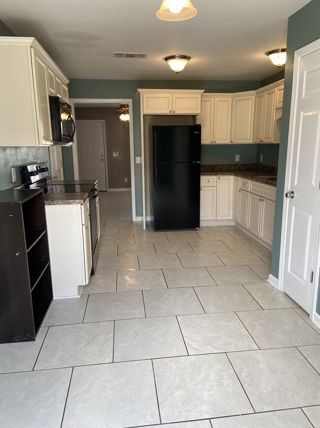 Large roomy Kitchen with ceramic tile, new paint ,all appliances stay with home.