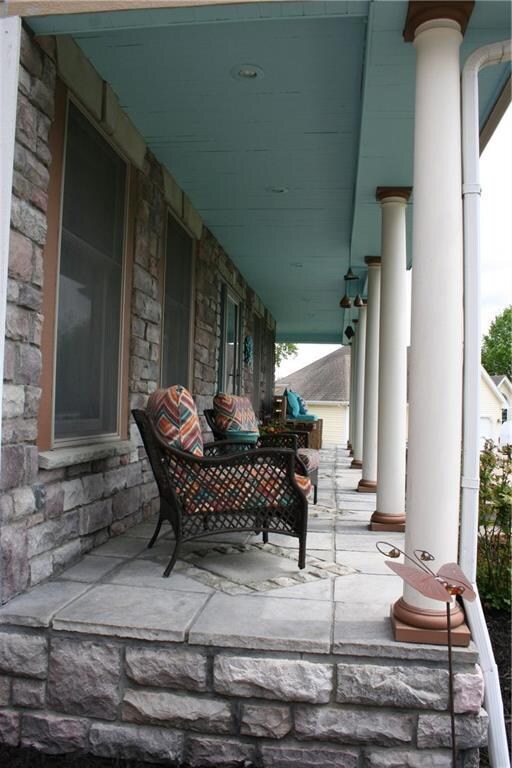 Front hearthstone porch which spans the entire wid