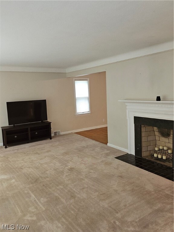 Unfurnished living room with light carpet