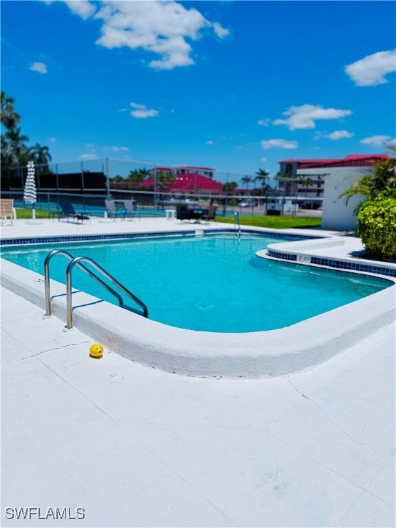 Community pool with a patio