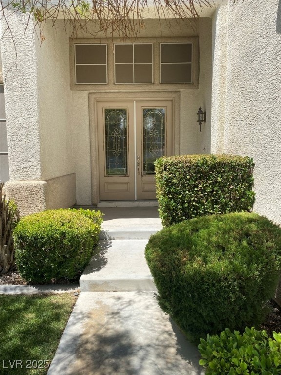 Entrance to property with stucco siding