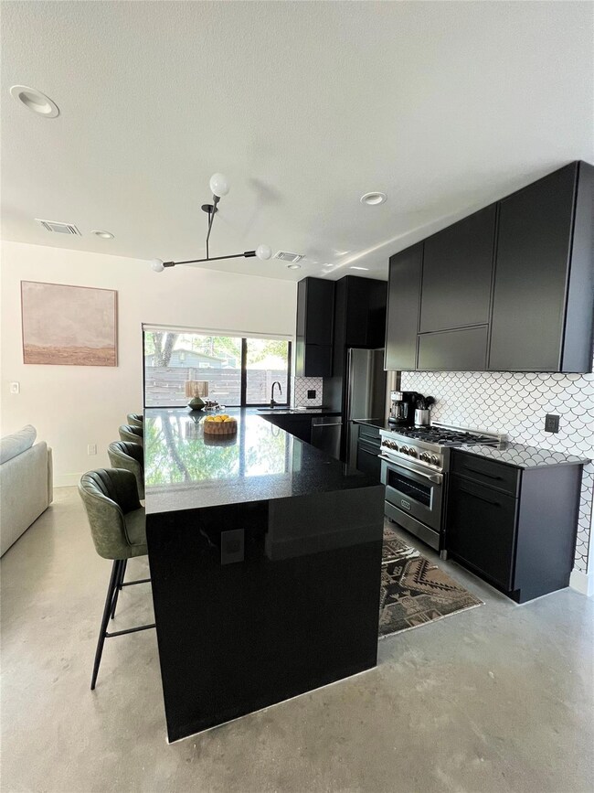 Kitchen with finished concrete floors, dark cabin