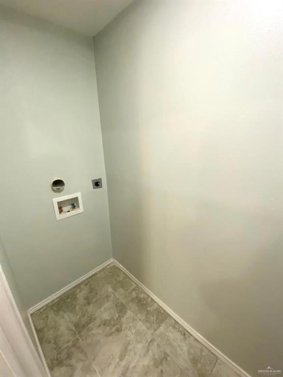 Clothes washing area with hookup for a washing machine, hookup for an electric dryer, and tile flooring