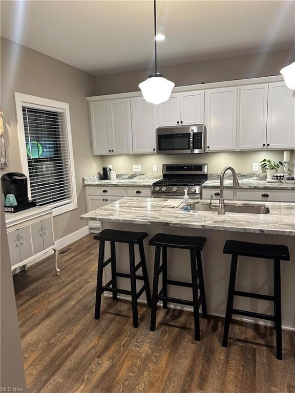 Kitchen featuring dark hardwood floors, decorative