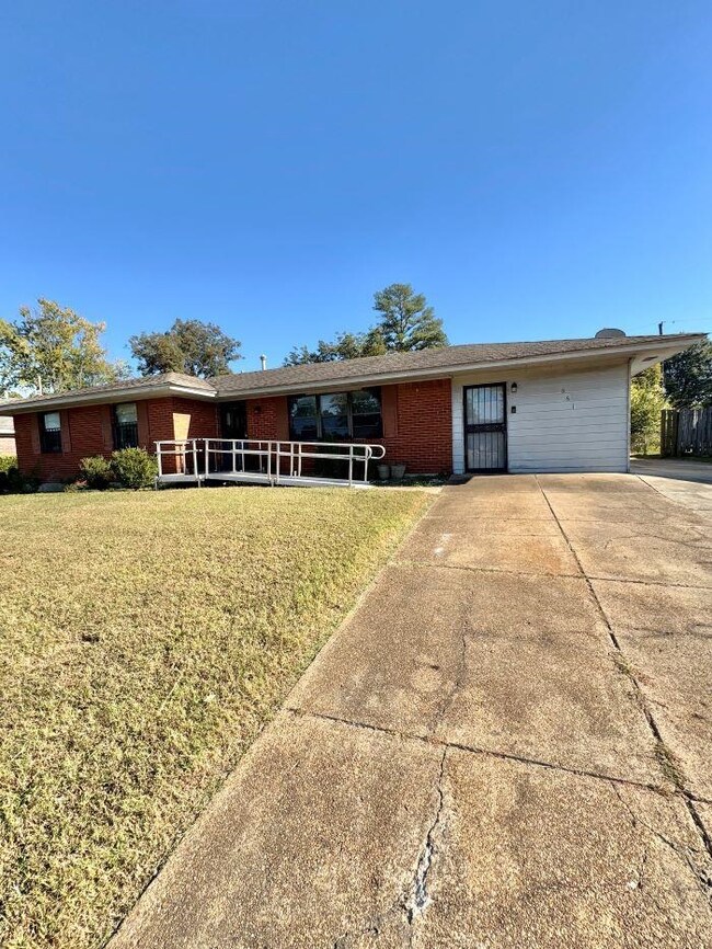 Single story home with a front lawn