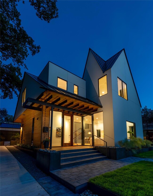 Back of house at night featuring a standing seam 