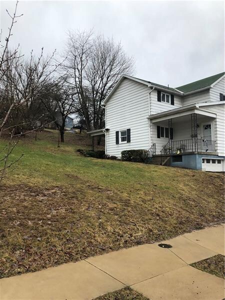 Side view of the home.  Empty lot next door gives 