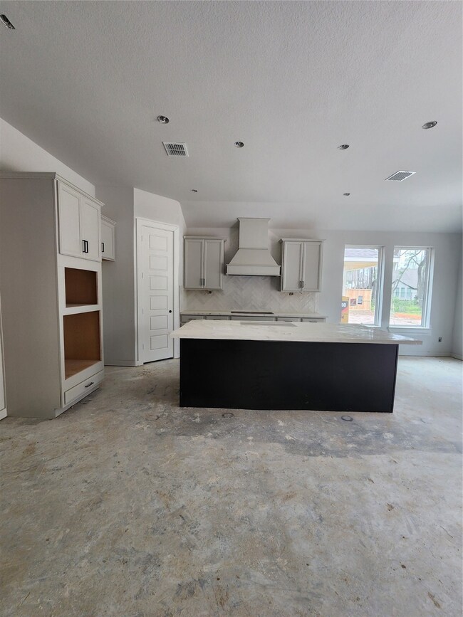 Kitchen with built in stainless steel microwave, oven, 5 burner cooktop and dishwasher.