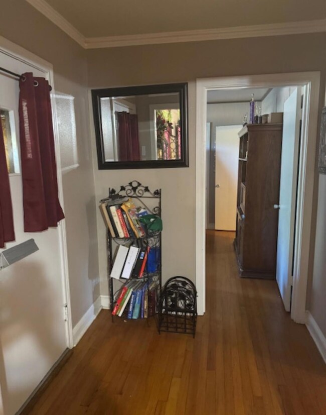 Corridor featuring crown molding and hardwood / wo