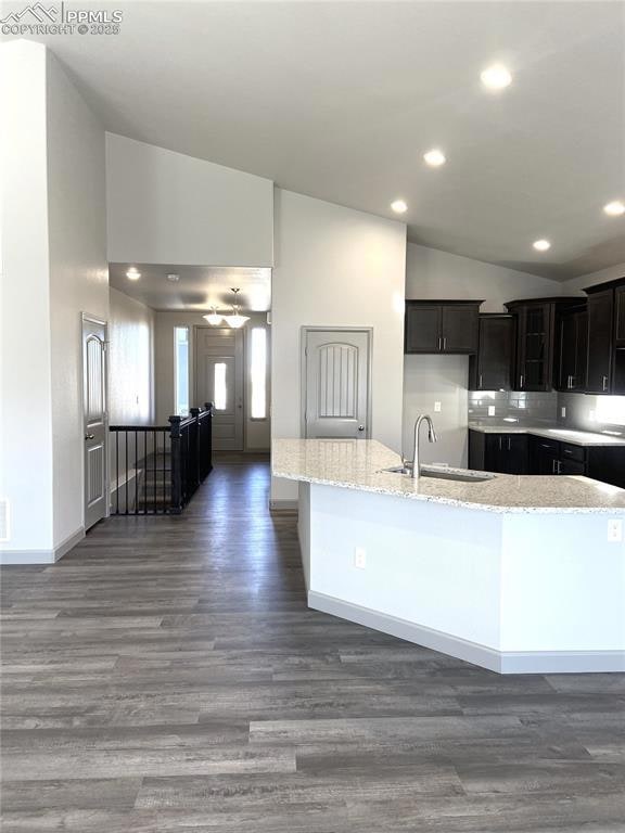 Kitchen with light stone countertops, backsplash, 