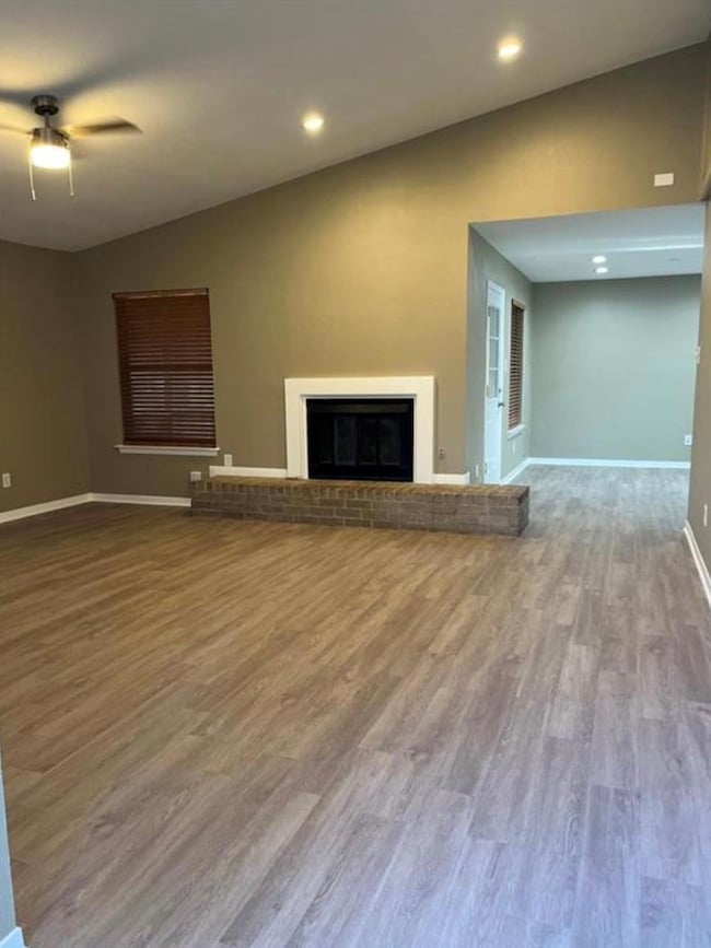 Unfurnished living room featuring baseboards, a c