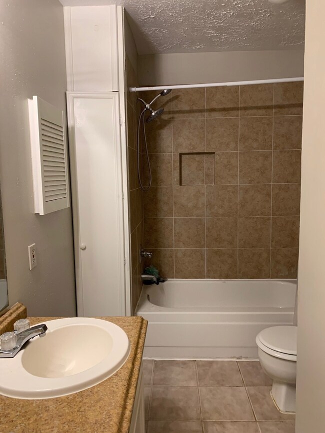 Master bath has tub with shower option.  Nice, neutral tile in that area with built in storage for toiletries. Linen storage, too.
