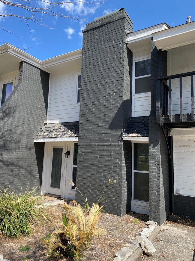 View of front of home featuring brick siding, a c