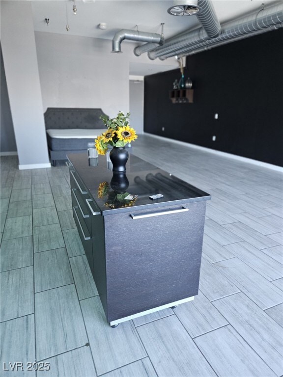 Kitchen featuring wood tiled floors, dark countert