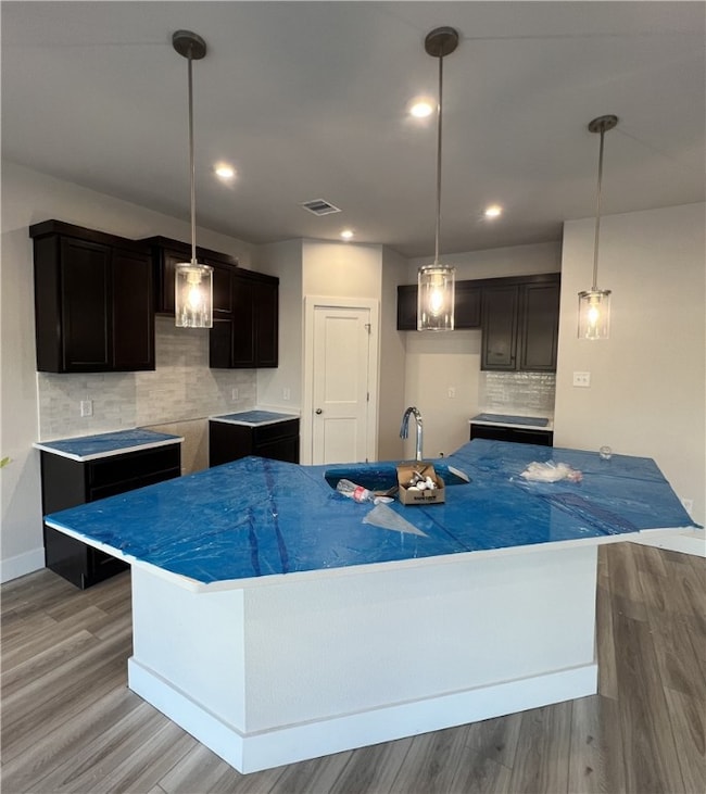 Kitchen featuring decorative backsplash, wood fini