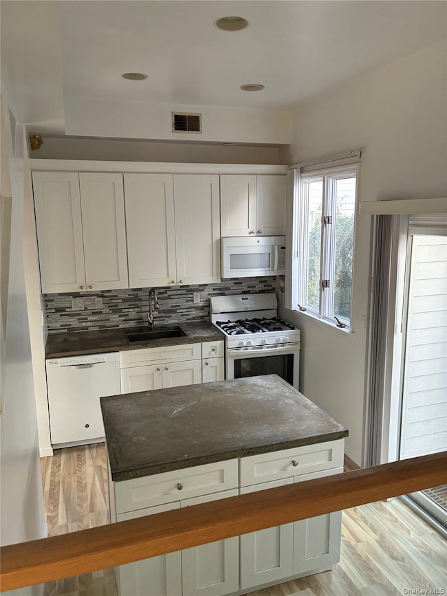 Kitchen featuring white cabinetry, and a center island