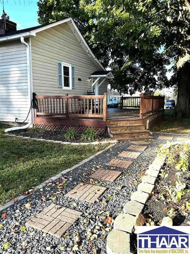 Landscaped path leads from driveway to large open 