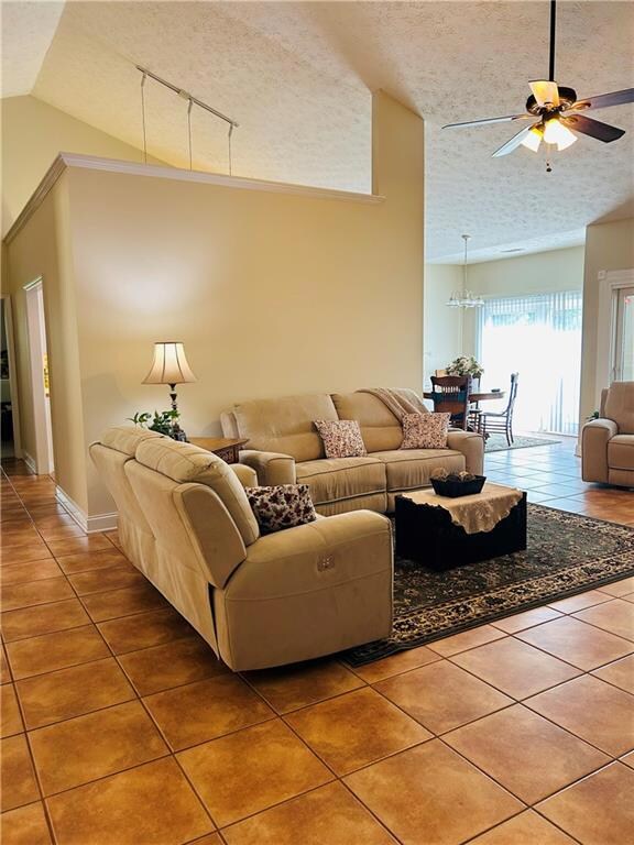 Tiled living room featuring a textured ceiling, ce