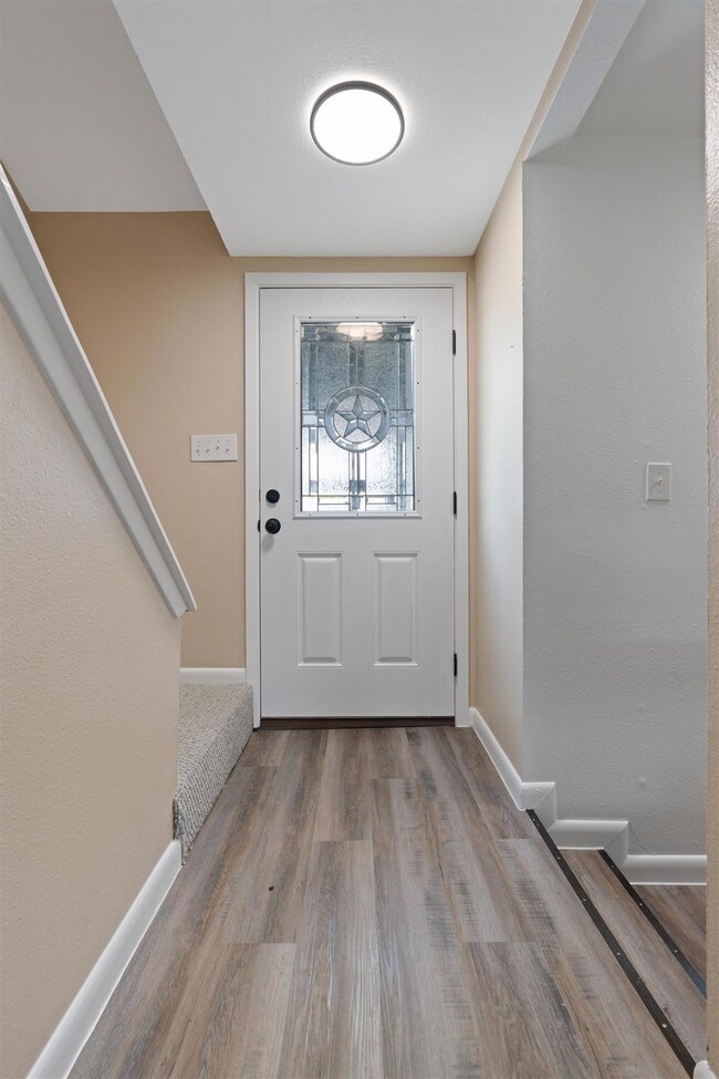 Entrance foyer featuring baseboards and wood fini