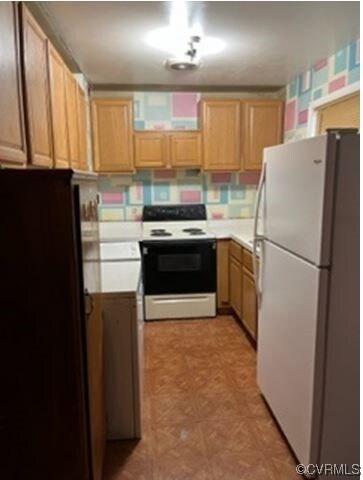 Kitchen featuring backsplash, light tile flooring,