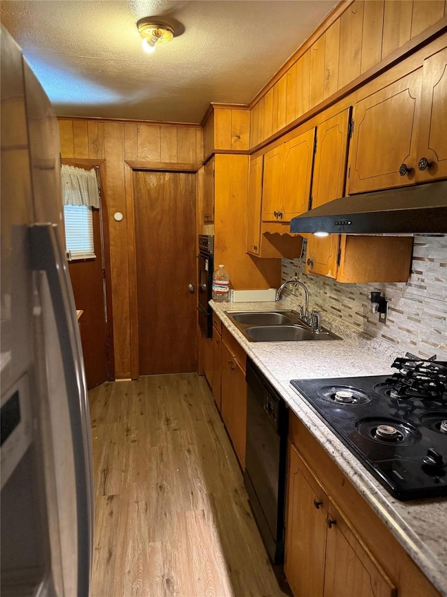 Kitchen featuring light countertops, under cabinet