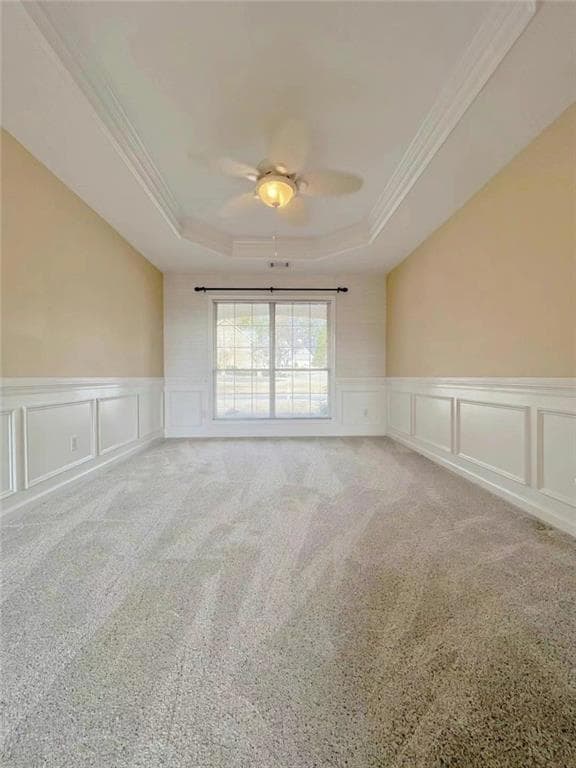 Unfurnished room with crown molding, a wainscoted 