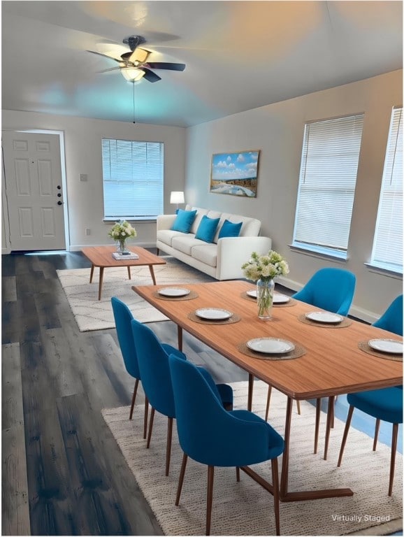 Dining room with dark wood-style flooring, a ceili