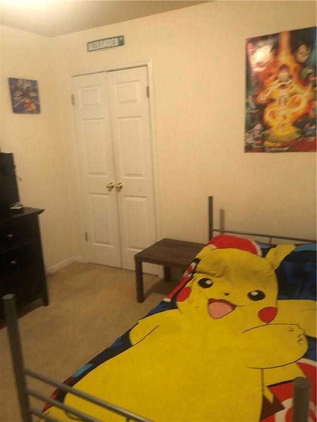 Bedroom featuring light colored carpet and a clos