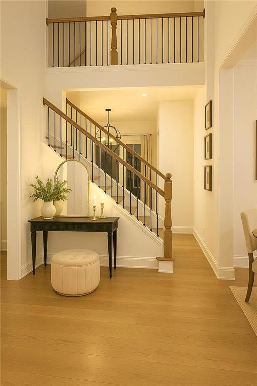 Staircase featuring a high ceiling, baseboards, a 