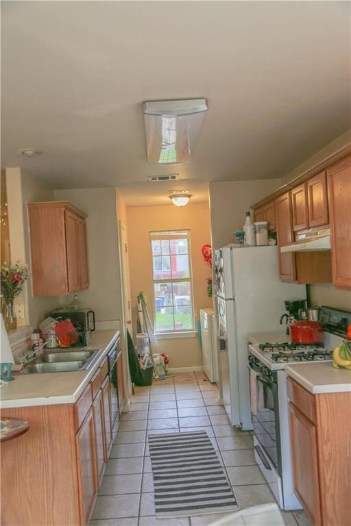 Kitchen featuring gas range, under cabinet range 