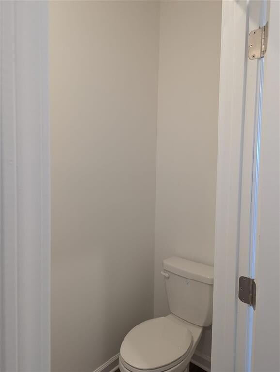 Bathroom featuring baseboards and toilet