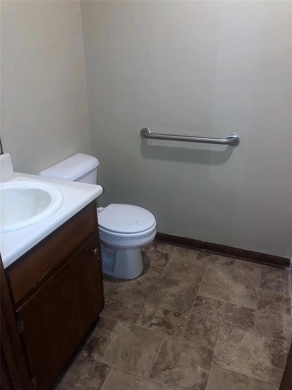Bathroom featuring vanity and dark stone finish floors