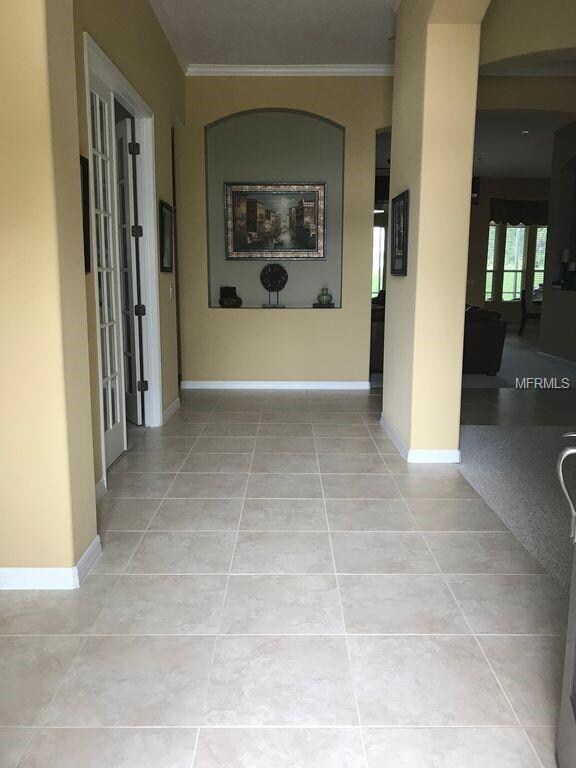 Tiled Foyer with Crown Molding