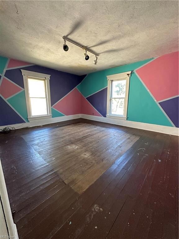 Additional living space with dark hardwood floors 
