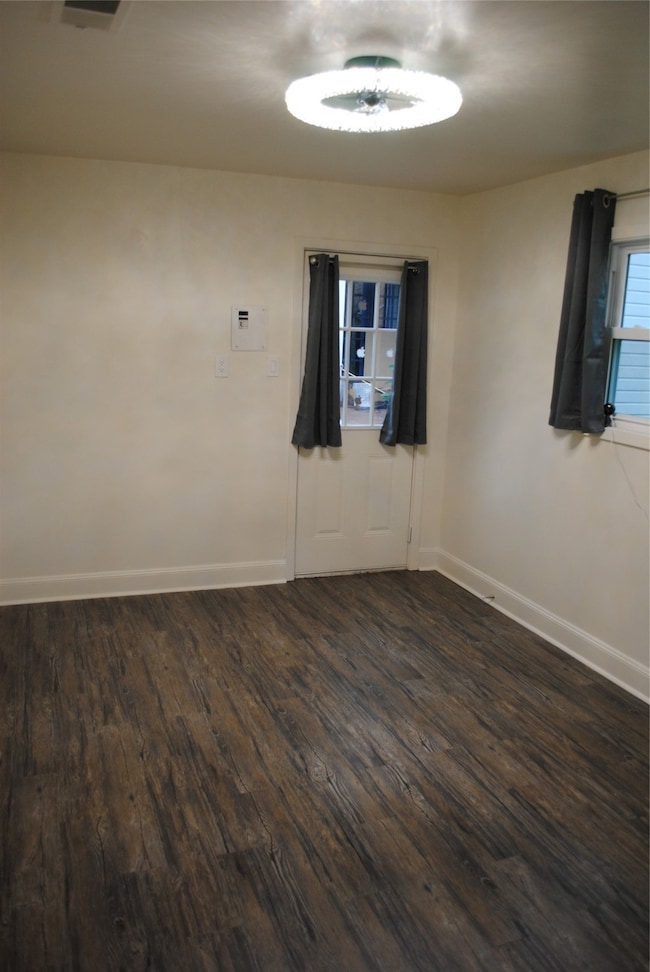 Cozy bedroom with elegant wood flooring, ample nat