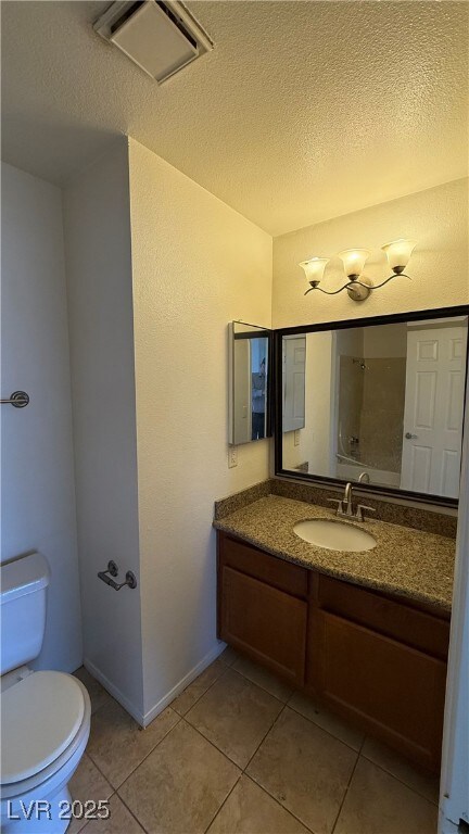 Bathroom featuring vanity, tile patterned floors,
