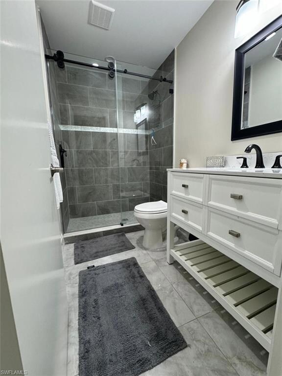 Contemporary and stylish with a walk-in shower, gray tile accents, and modern fixtures.