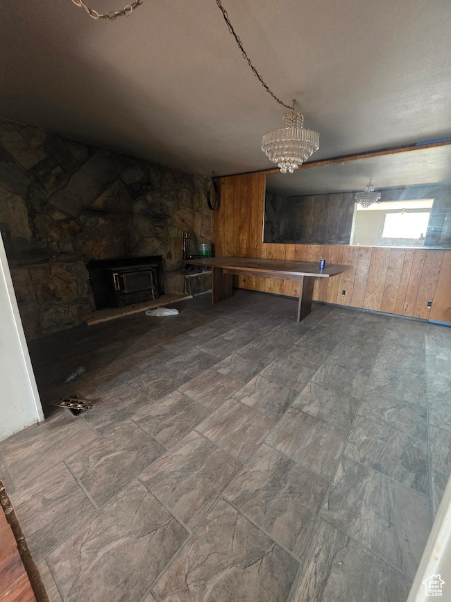 Game room with wooden walls and a chandelier