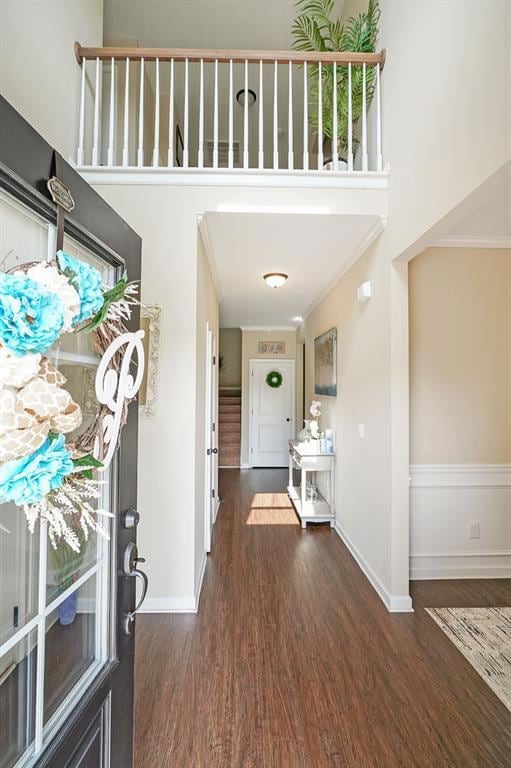Foyer entrance with baseboards, dark wood-style fl