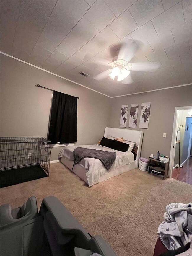 Carpeted bedroom with ceiling fan
